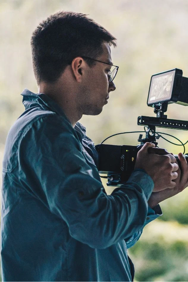 Freelance photographer capturing lifestyle portraits outdoors with natural lighting and creative composition.