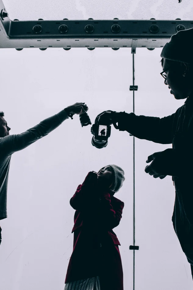 Commercial product photographer collaborating on a creative shoot with lighting and props to frame a hero product shot.