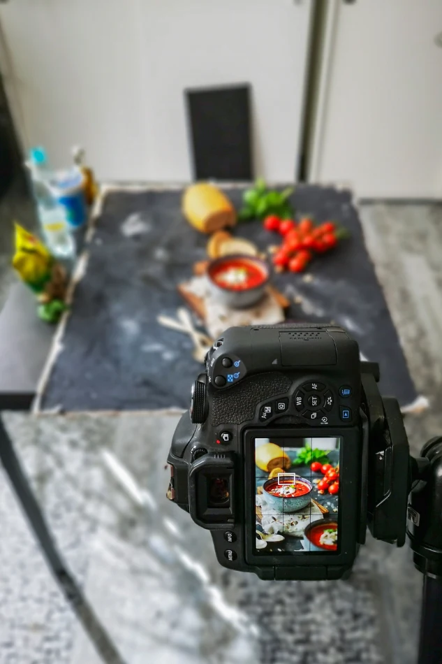 Product photographer shooting a styled flat lay of food items, optimizing color, texture, and placement for visual impact.