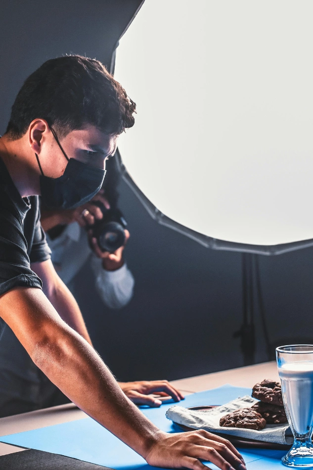 Freelance photographers adjusting lighting for commercial product photography