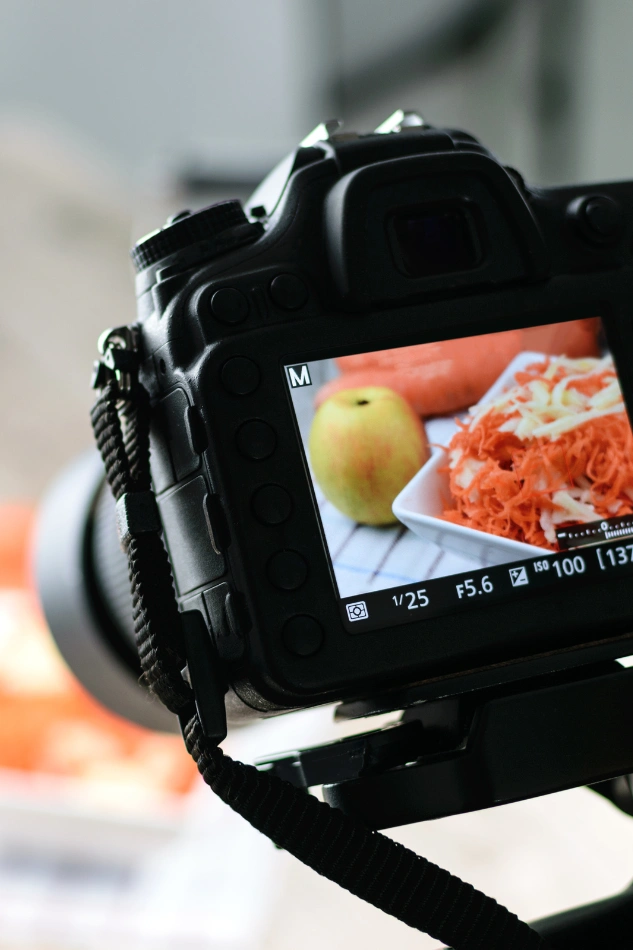 Close-up of DSLR capturing food setup during a business photo shoot