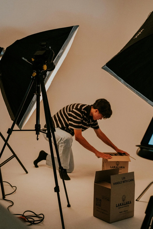 Behind-the-scenes setup for branding video featuring product packaging under studio lighting.