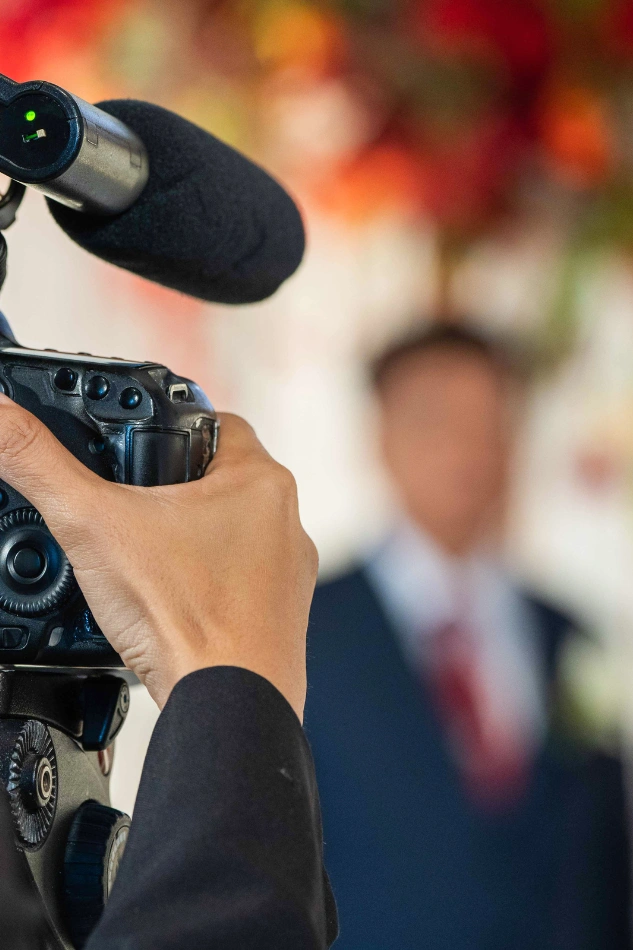 wedding videographer capturing vows with professional gear